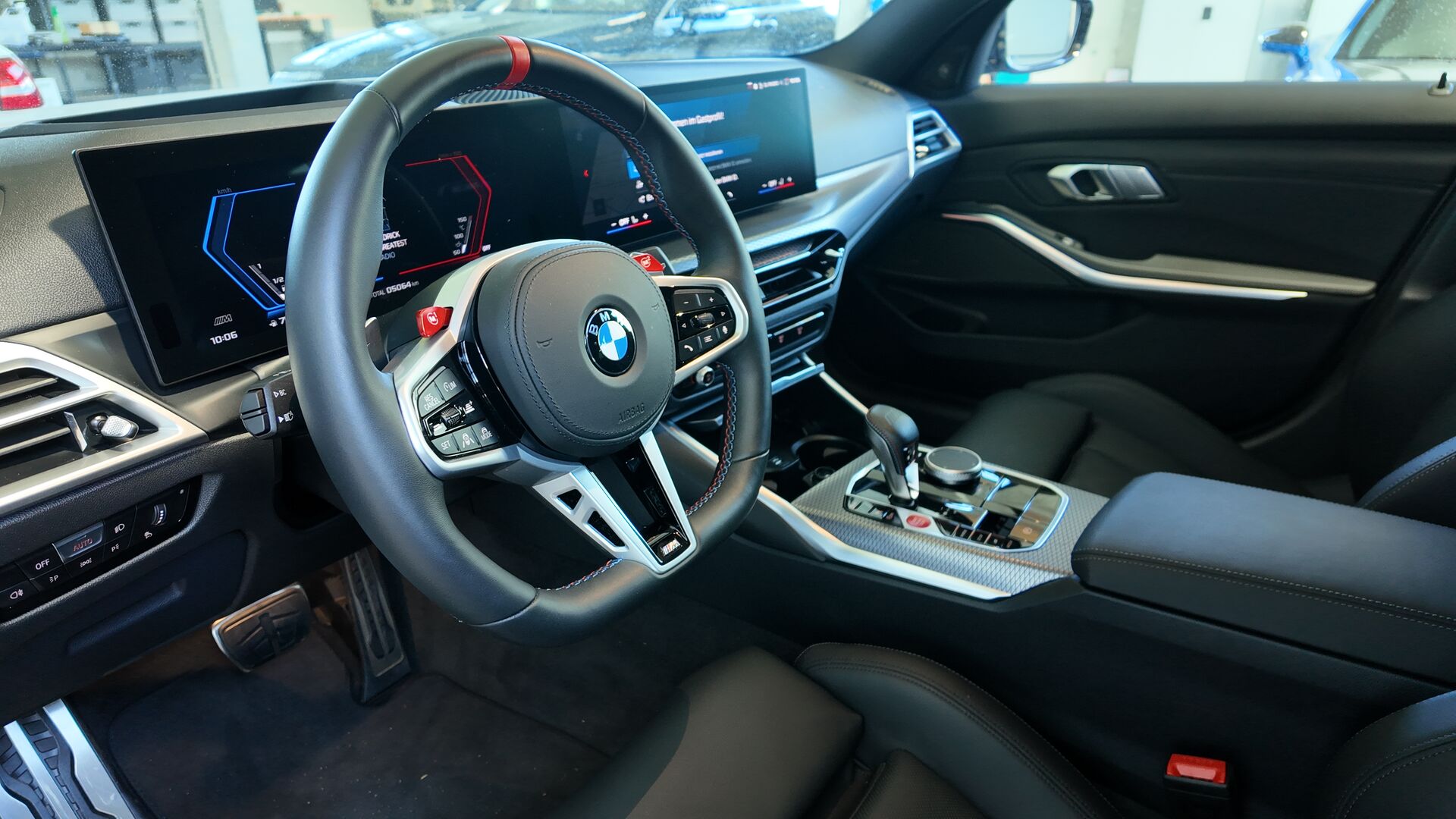 Cockpit eines BMW M3 Touring mit Lenkrad, Armaturenträger, Mittelkonsole, Türverkleidung und Fahrersitz